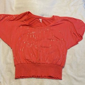Salmon colored sequin Studio Y short sleeved shirt with elastic bottom, size L.